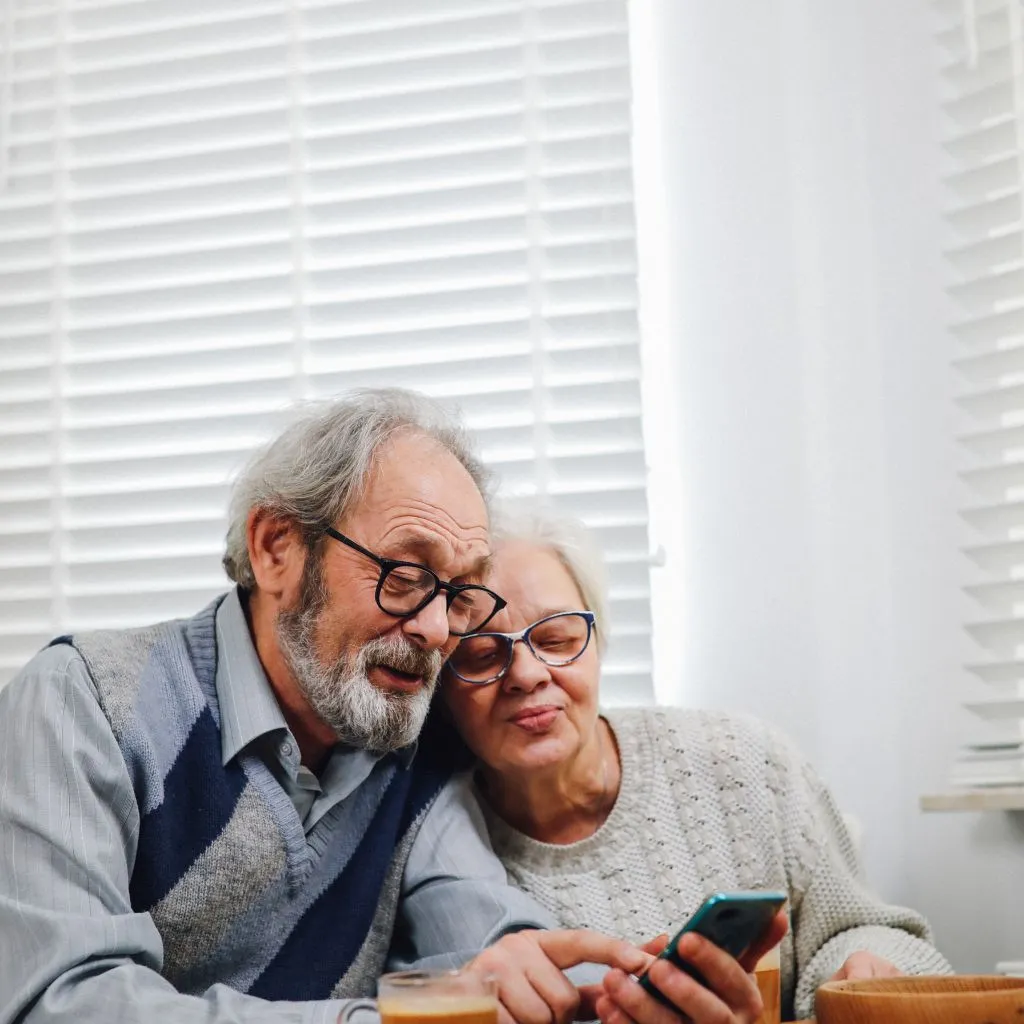 A couple of seniors checking their phone - Why book with us Trindet Holiday Homes - Installments Plan